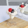 Delicious dessert with ice cream, berries, and a cherry in a clear glass cup.