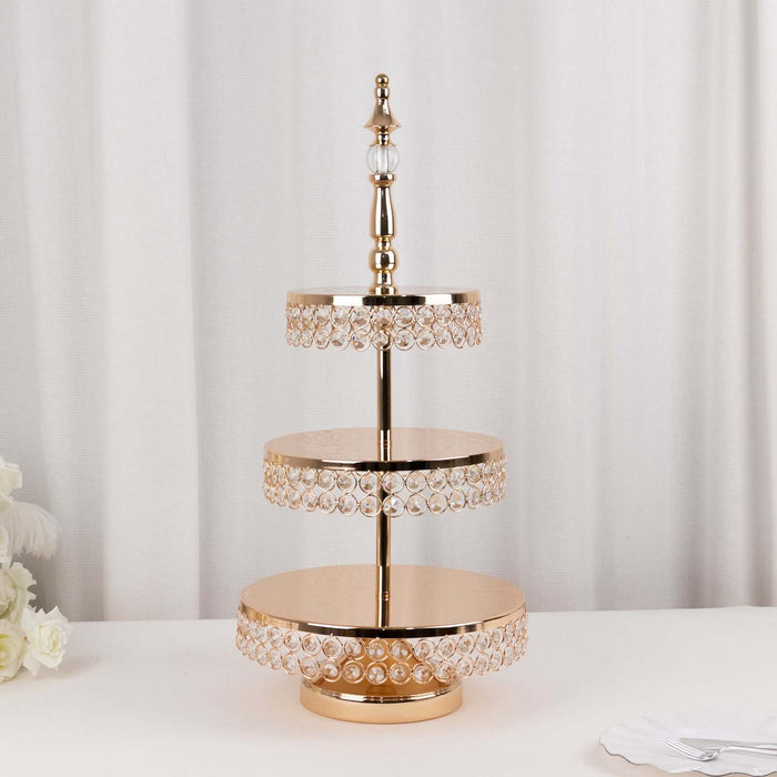 Elegant three-tier cake stand with crystal accents and a gold finish.