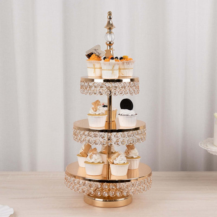 Gold cupcake stand with decorative crystals and assorted cupcakes.