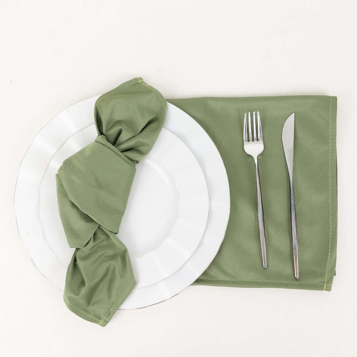 Green napkin elegantly wrapped on white plates with silver cutlery