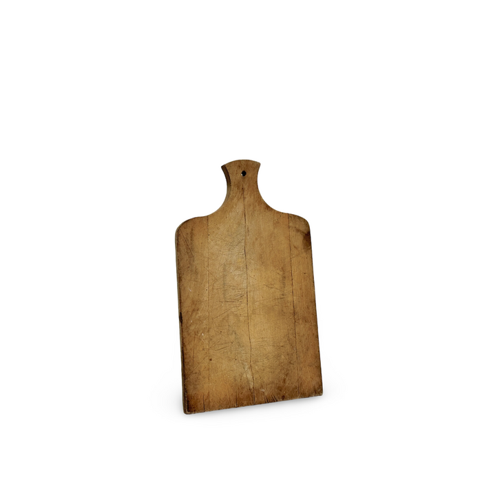 Antique wooden bread board with curved top and hanging hole, worn grain