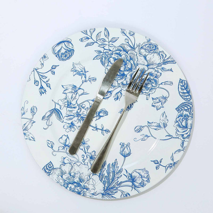 Floral patterned dinner plate with knife and fork on a white background