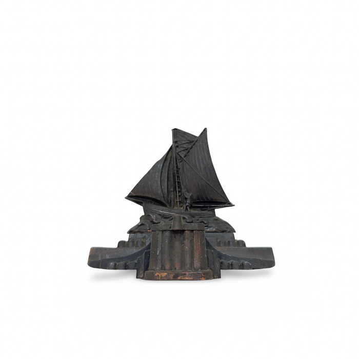 Antique boat-shaped inkwell with raised sail detail, dark patina metal base