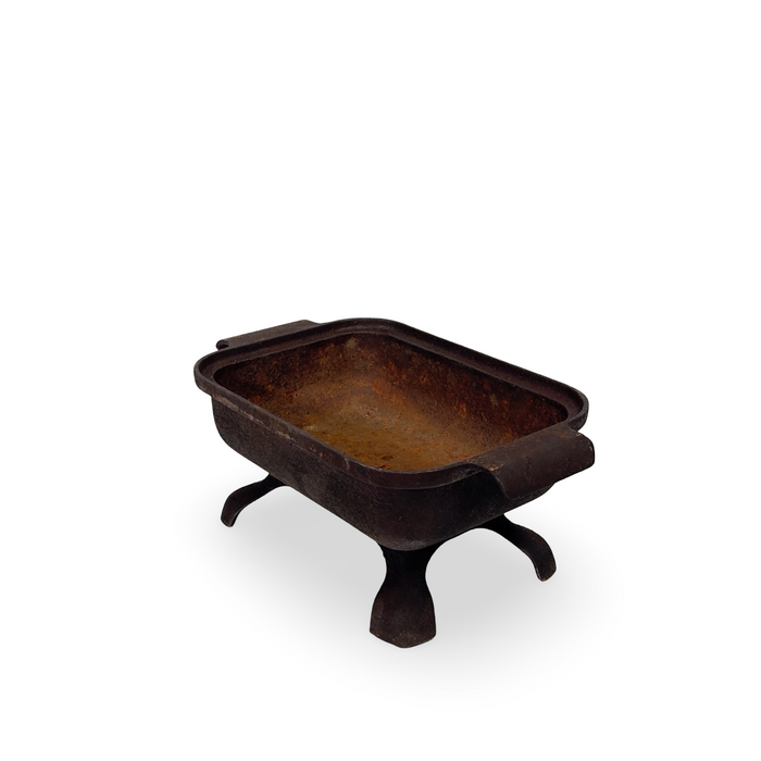 Antique dark cast iron basin on three curved feet, open top view