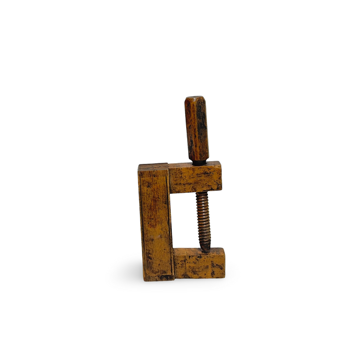 Antique wooden vice clamp with threaded metal screw and two vertical jaws