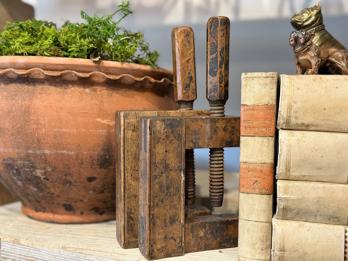 Antique wooden vice with two patina-worn jaws and exposed threaded screw