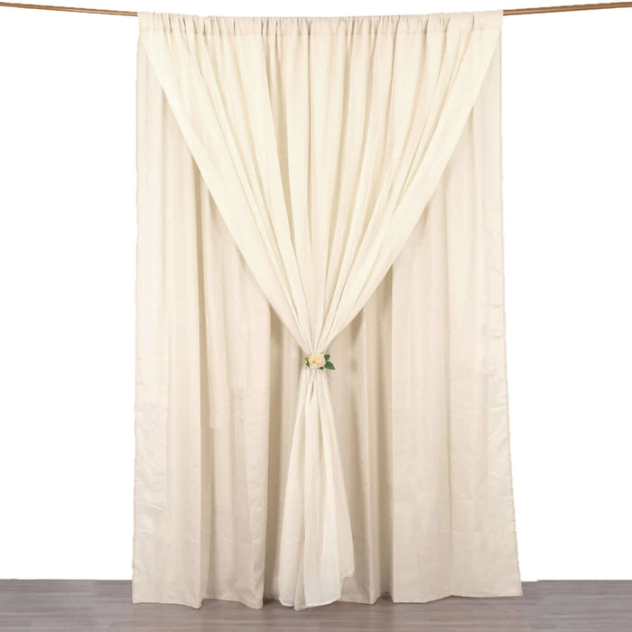 Cream curtain draped elegantly with a floral tieback on a white backdrop