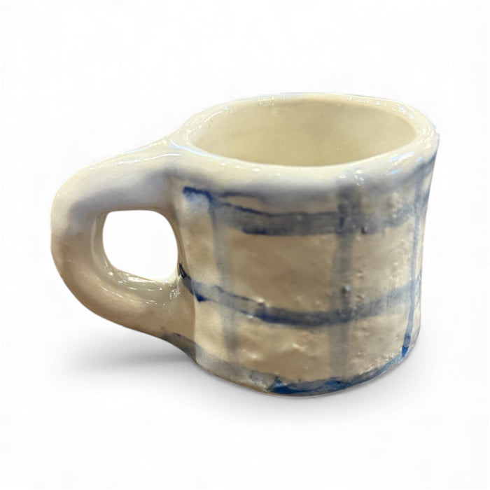 Handmade ceramic mug in off-white with blue glaze stripes, wide handle