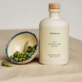 Bottle of Branche No 2 extra virgin olive oil with label, plus bowl of green olives