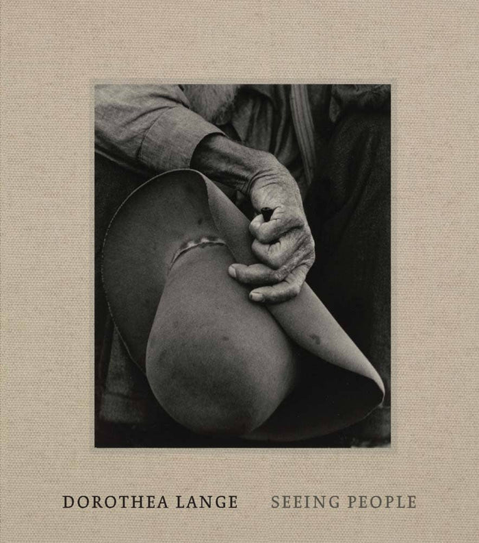 Hardcover photo book; beige cover with black-and-white portrait on front panel