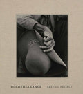 Hardcover photo book; beige cover with black-and-white portrait on front panel