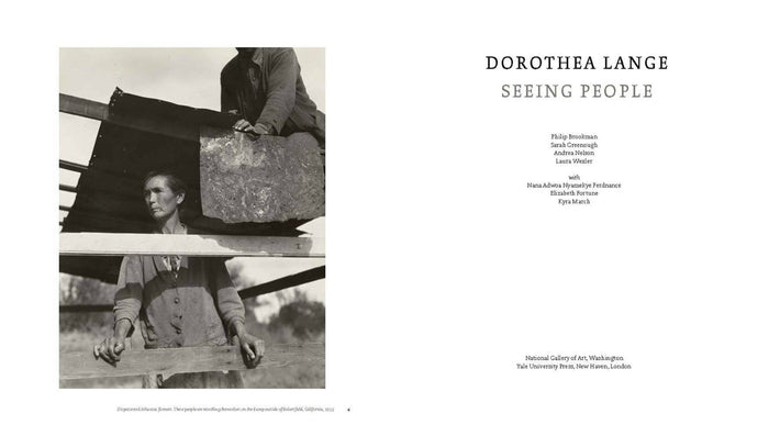 Hardcover photo book open spread with two black-and-white photos and caption text