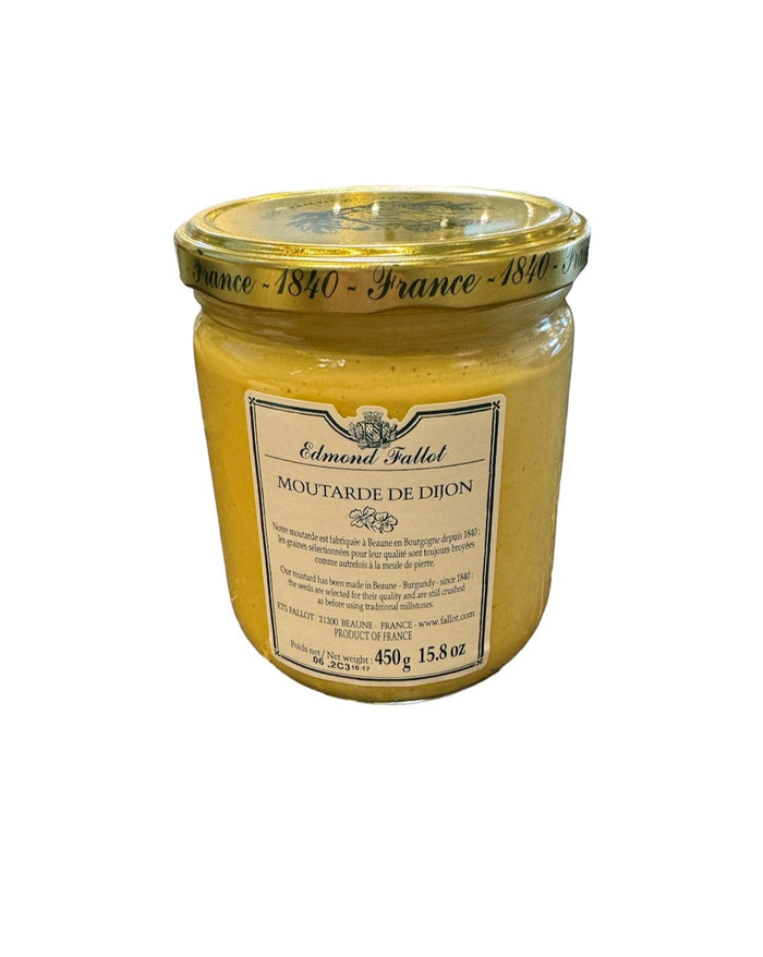 Glass jar of Dijon mustard with yellow contents and front paper label