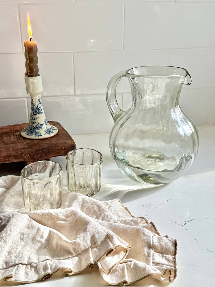 Clear glass fluted pitcher with loop handle and textured fluted sides