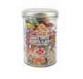 Clear jar with white lid of assorted flower-shaped honey sweets