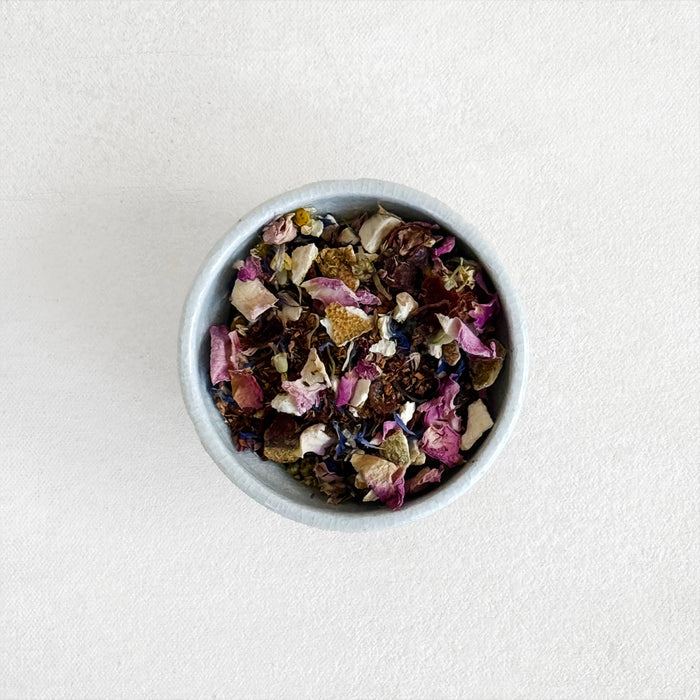 Herbal tea leaf mix in small bowl, top view