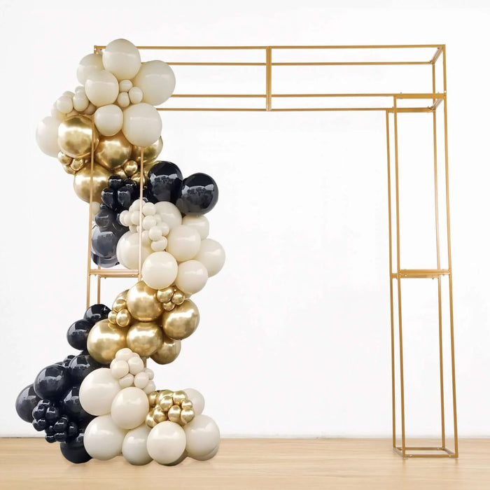 Gold, black, and white balloon arch with a metallic frame.