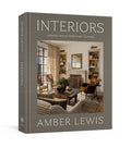 Interiors design book with “INTERIORS” title on gray hardcover, by Amber Lewis
