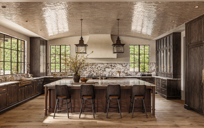 Interior design book page featuring kitchen with island and bar stools