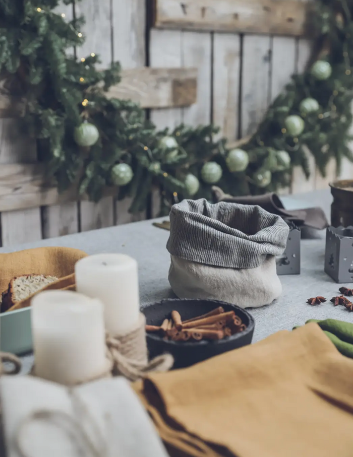 Gray linen storage basket on table with folded opening