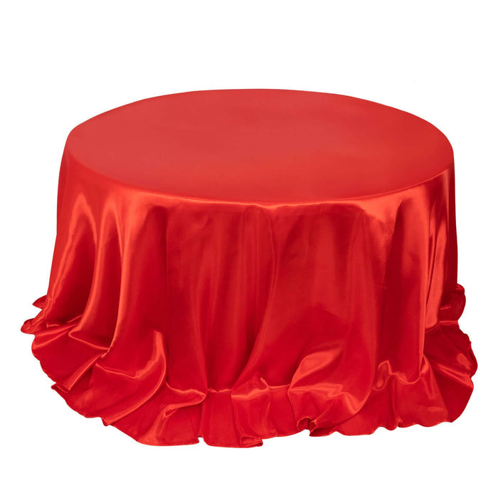 Red satin tablecloth with ruffled edges, perfect for events or decor.