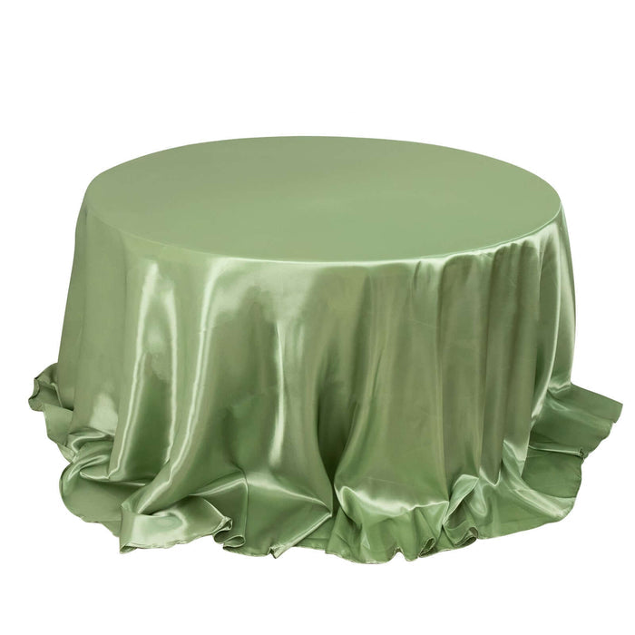 Green satin tablecloth draped elegantly over a round table.