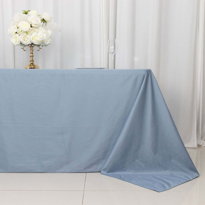 Blue tablecloth draped elegantly over a table with floral centerpiece.