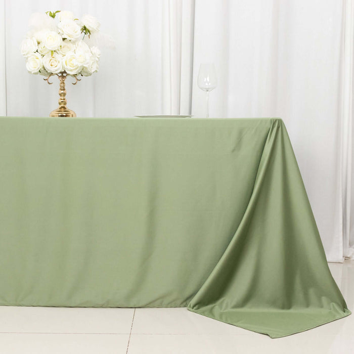 Green tablecloth draped elegantly over a table with a floral centerpiece.