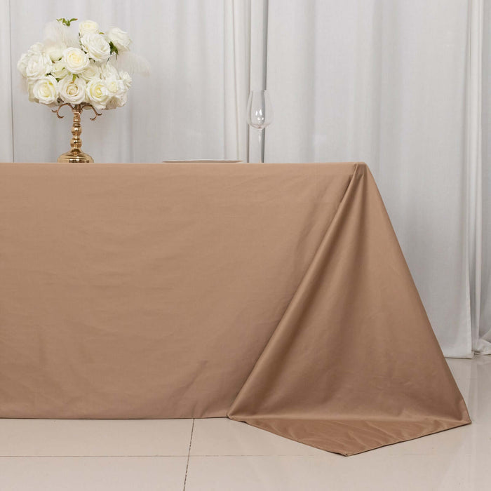 Brown tablecloth draped elegantly on a table with floral centerpiece.