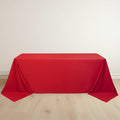 Red tablecloth draped over a table on a plain background