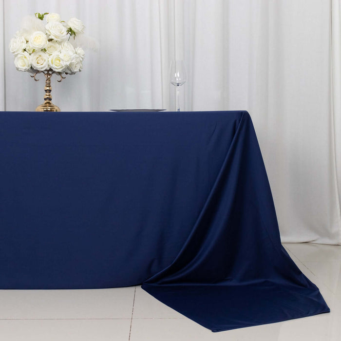 Navy blue tablecloth draping elegantly on a table with floral centerpiece