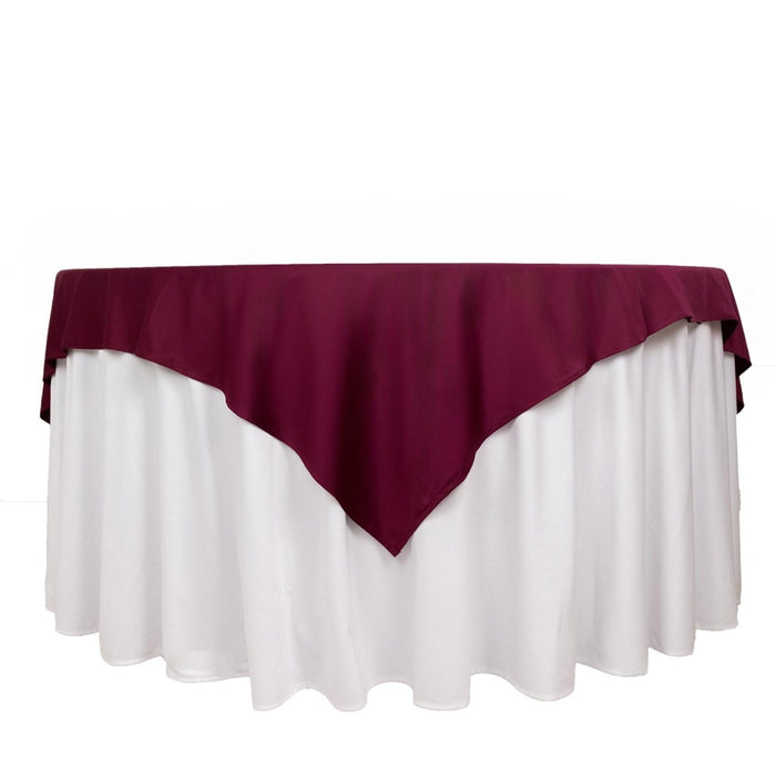 Burgundy and white tablecloth draped elegantly over a round table