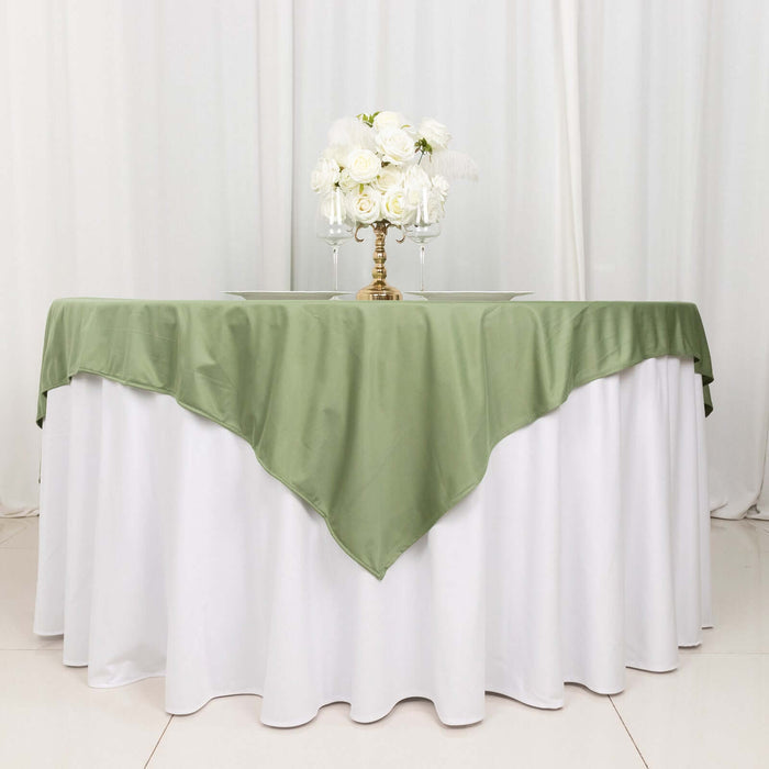 Elegant green tablecloth draped over a white table with floral centerpiece