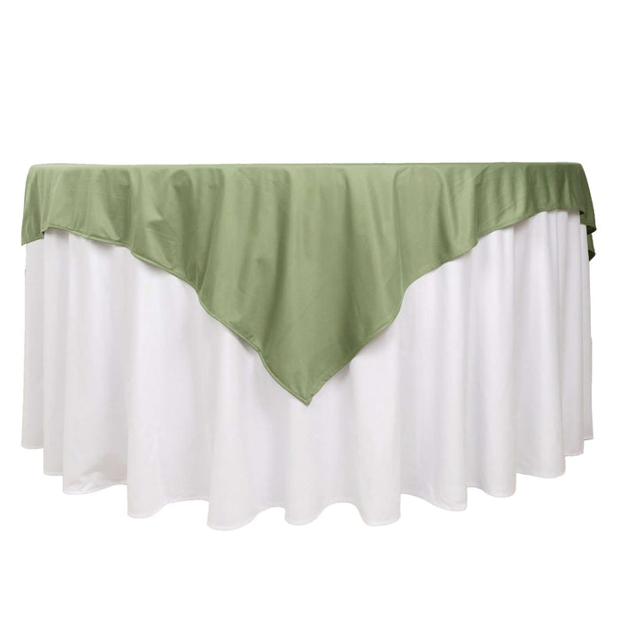 Green tablecloth draped over a white table for elegant decor.