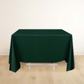 Dark green tablecloth draped over a table in a light room.