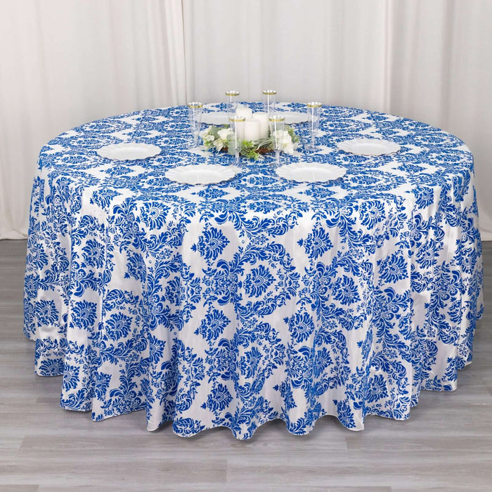 Blue and white floral tablecloth on round table.