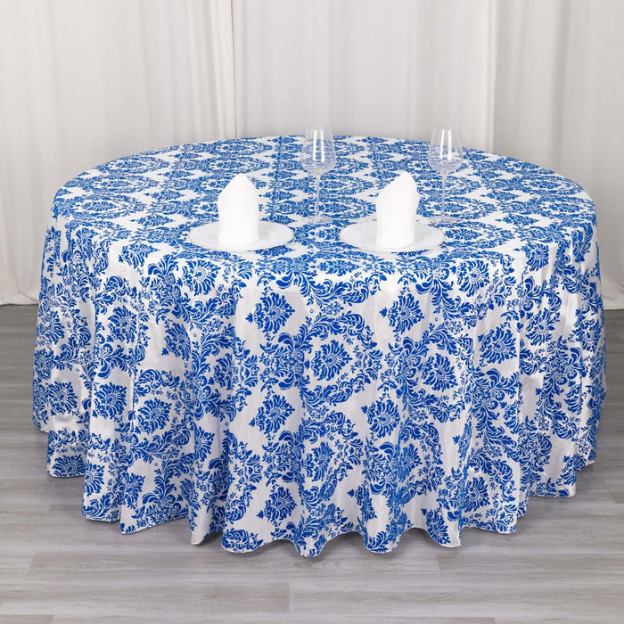 Round blue and white floral tablecloth on a dining table.